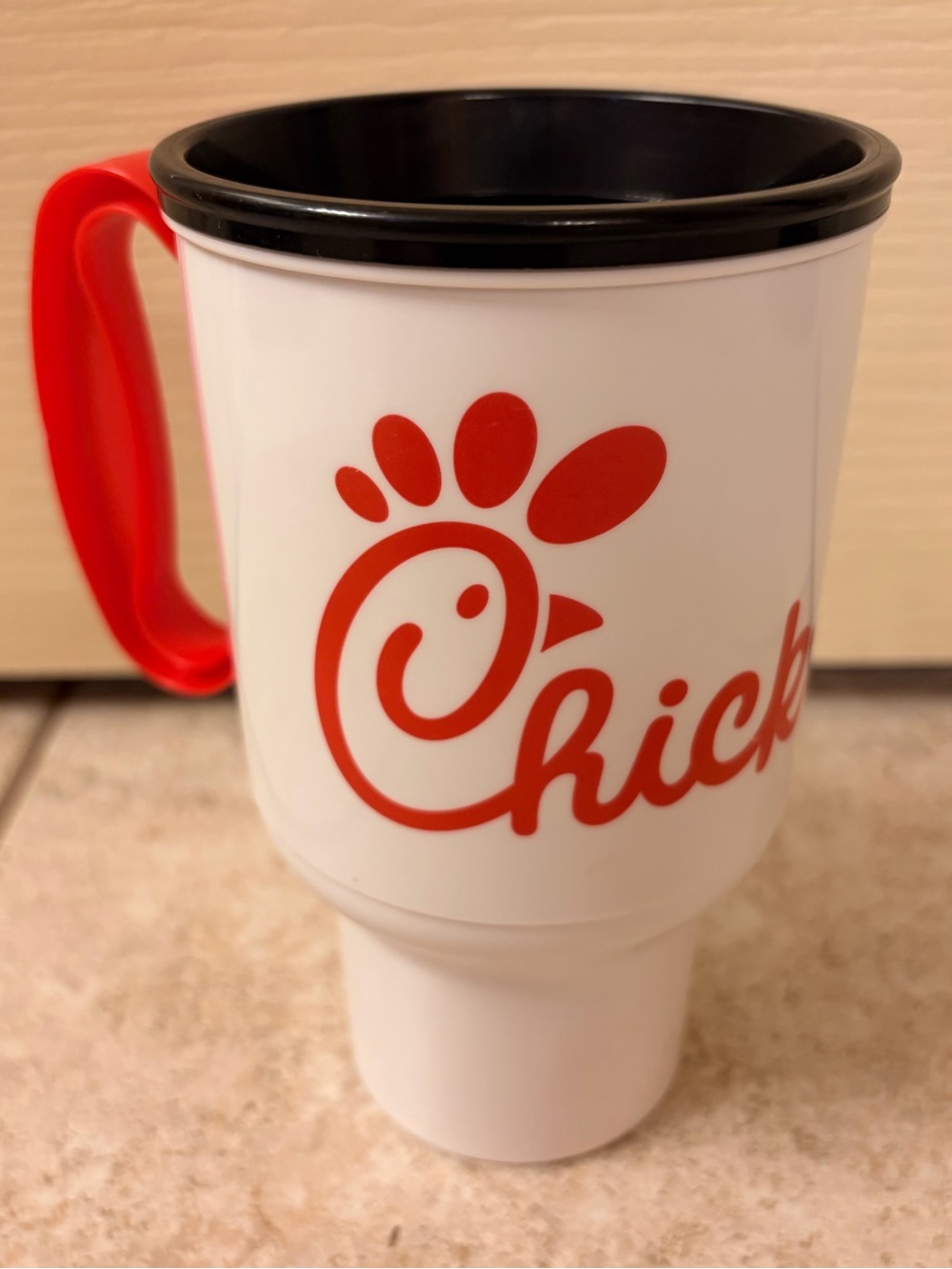 Chick-fil-a 20 oz travel cup, white and red, no lid.